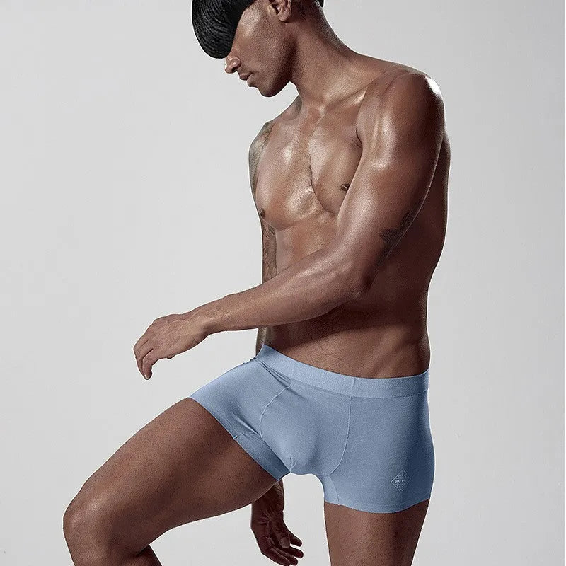 Seamless men's modal underwear in green colour showing mid-waist design and solid colour construction