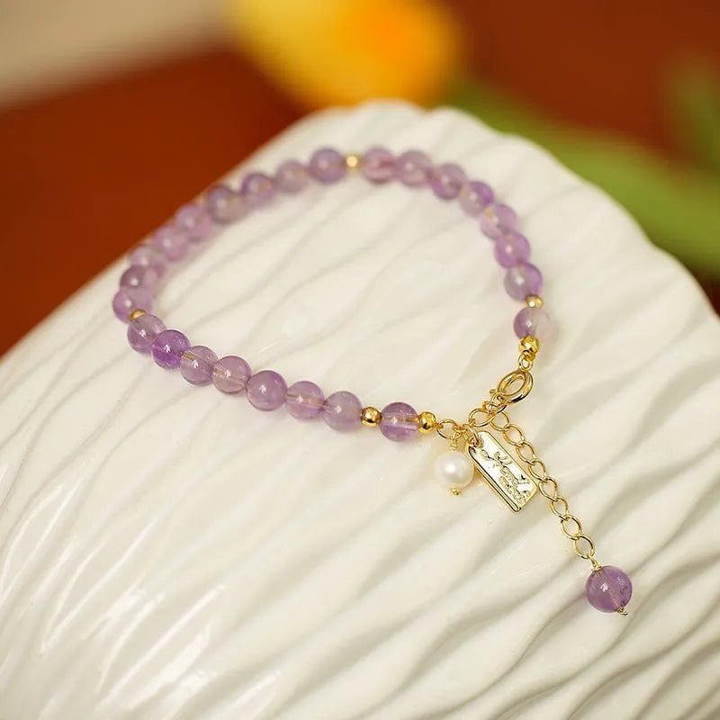 Natural crystal lavender amethyst bracelet for women in dark and light colour variations on a wrist.