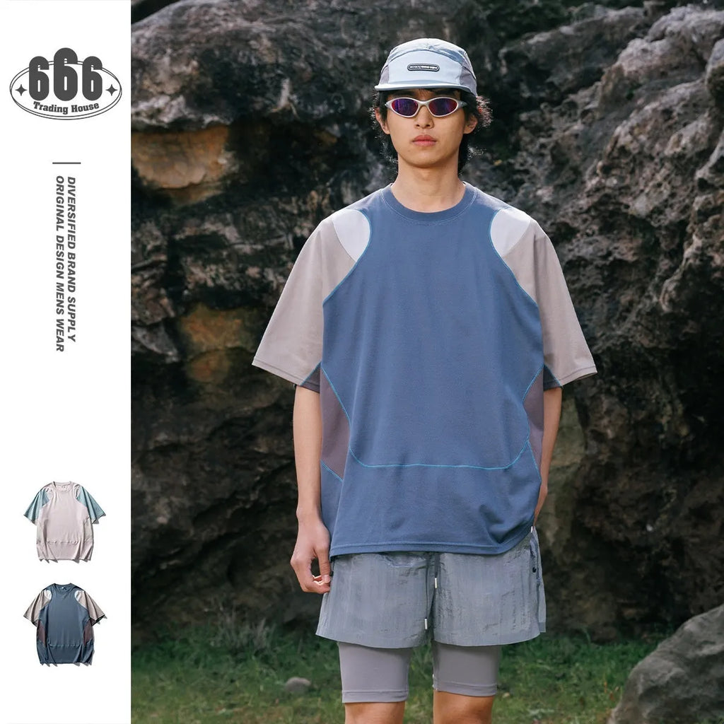 Men's loose blue patchwork t-shirt with raglan short sleeves on a white background.