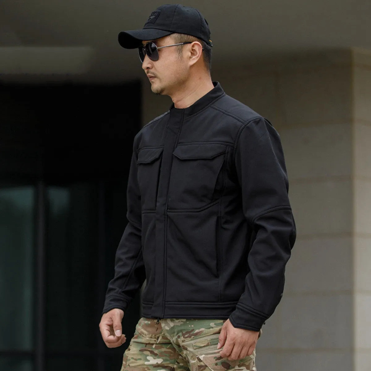 A black soft shell jacket for mountaineering and camping, shown in a cardigan style.