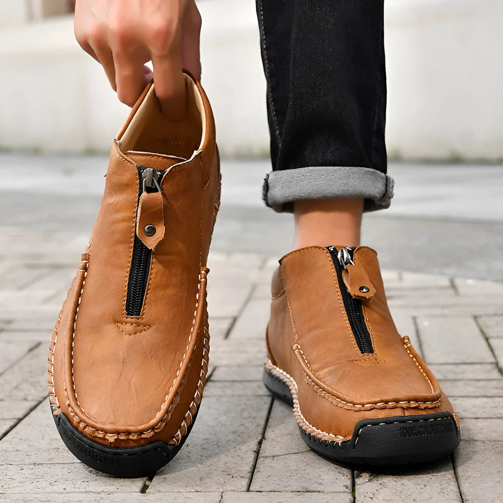 Men's black slip-on casual loafers with round toe and rubber sole on a white background.