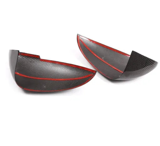 Pair of black true carbon fibre rearview mirror covers for Porsche Macan, showing textured weave pattern.