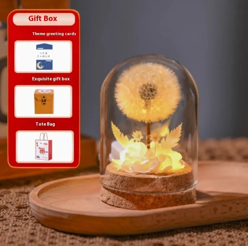 Dandelion-shaped glass night light ornament in gradient colours on wooden surface
