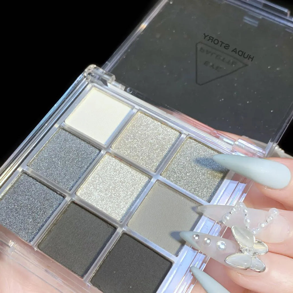 Nine-colour smoked eye shadow plate showing white, silver, black, and iron grey shades in INS style case