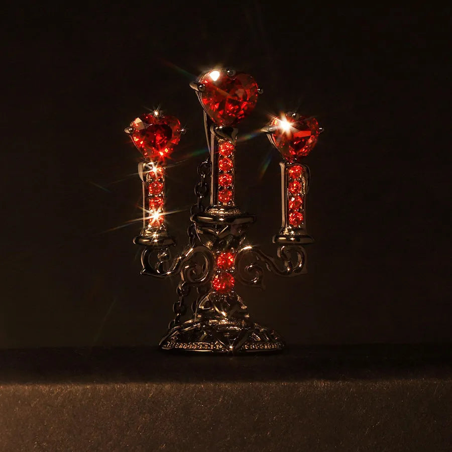Women's silver Gothic necklace featuring a hollow candlestick pendant on a cross chain.