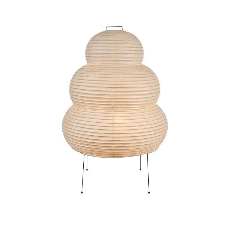 Japanese style table lamp with handmade paper shade and aluminium base on a wooden surface.