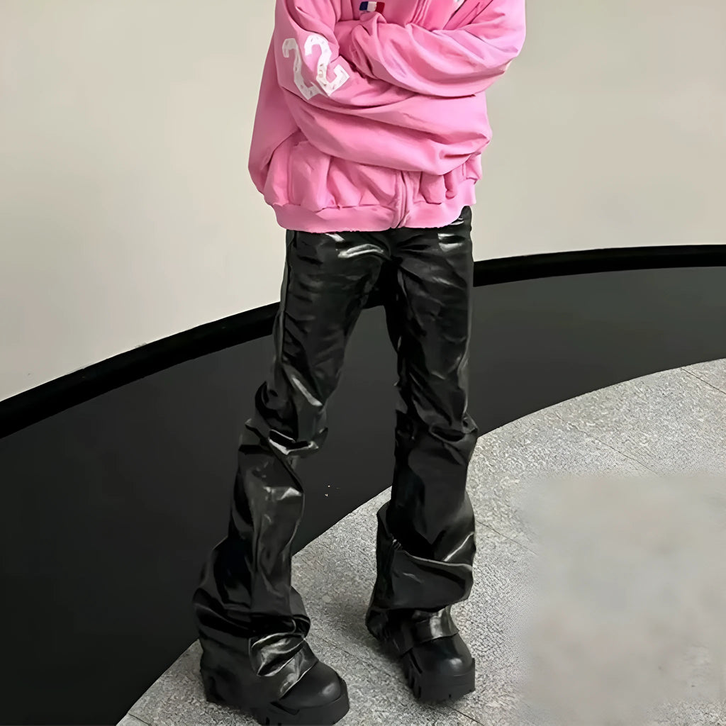 Black shiny patent leather coated skinny jeans on a denim background.