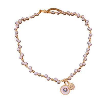 Gold-white electroplated necklace with round imitation pearl and zircon pendant on an adjustable clavicle chain.