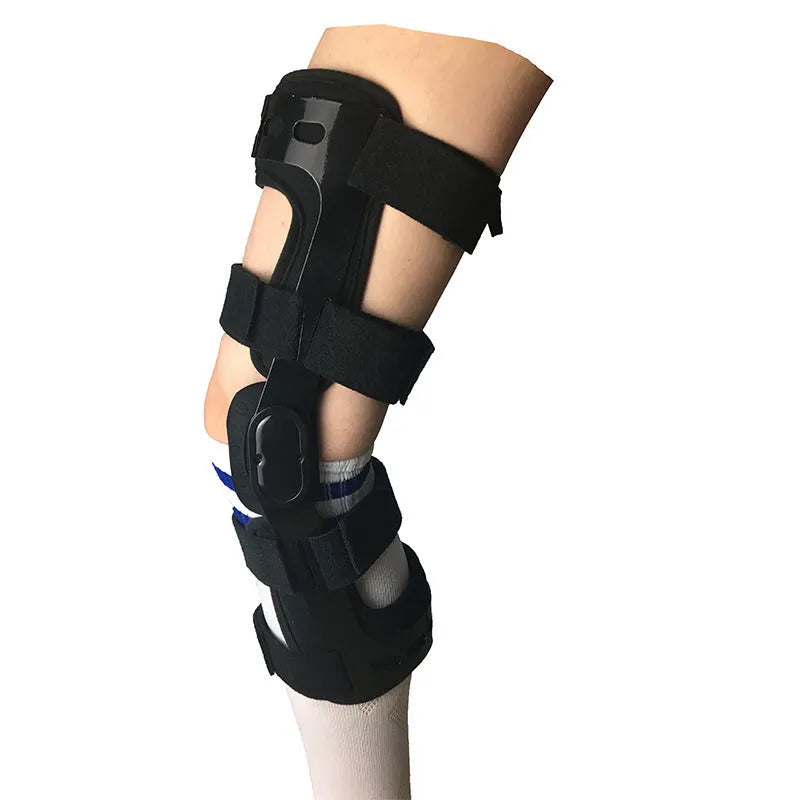 Black anterior ligament knee pad with visible metal stabiliser, shown in a left-leg size.