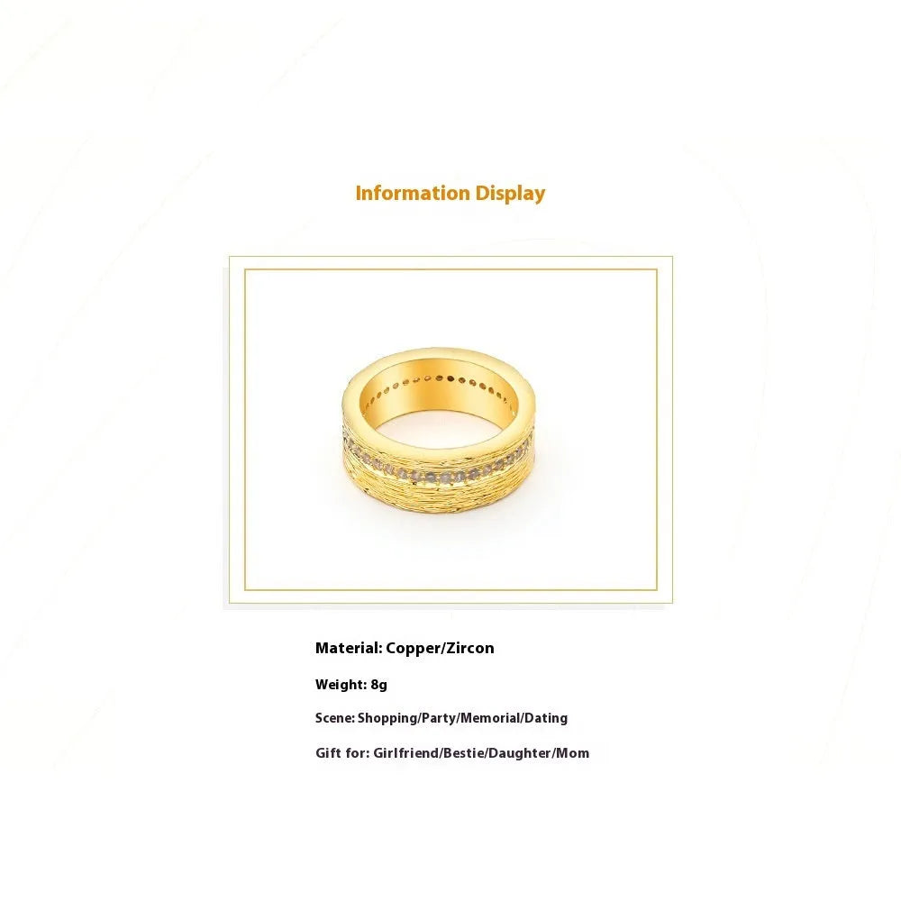 Geometric gold-coloured zircon ring for women on a plain background.