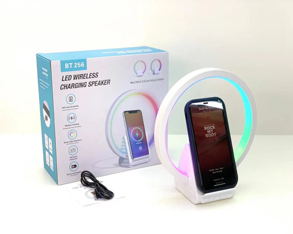 White smart Bluetooth speaker with wireless charging surface and LED ambience lighting
