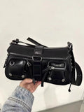 Black women's baguette style messenger bag with adjustable shoulder strap shown from front.