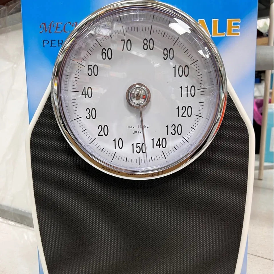 Black mechanical bathroom scale with large dial on a 47x35 cm platform.