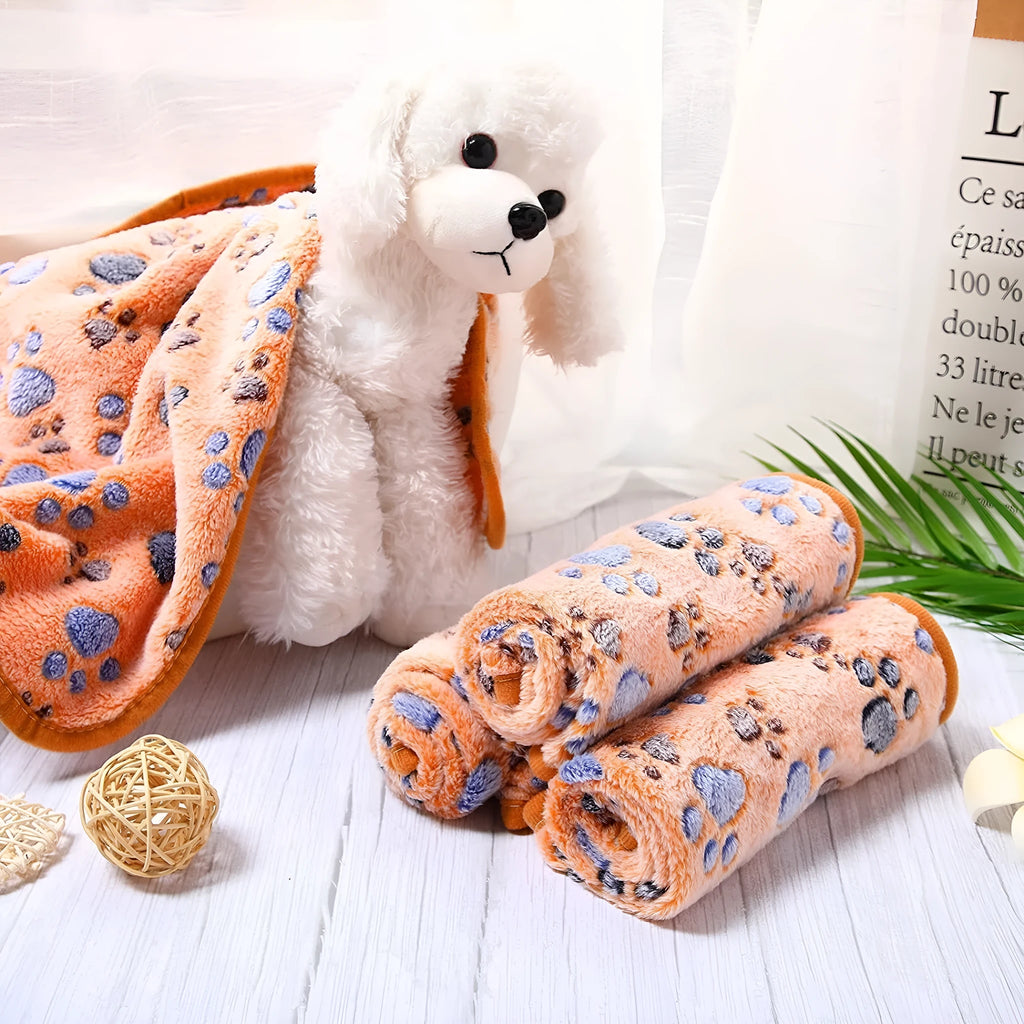 Coral fleece dog blanket with paw print design in multiple size options