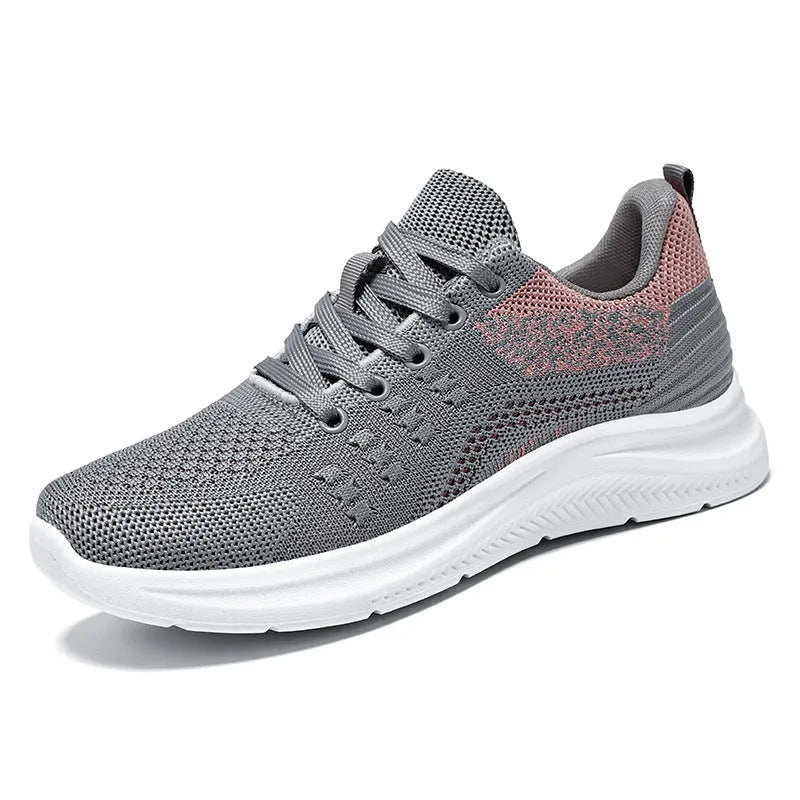 Women's black mesh low-top sneakers with round toe and white PVC sole on a neutral background.