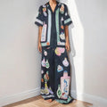 Black women's casual set with anime cartoon print, featuring a long sleeve cardigan and matching trousers.