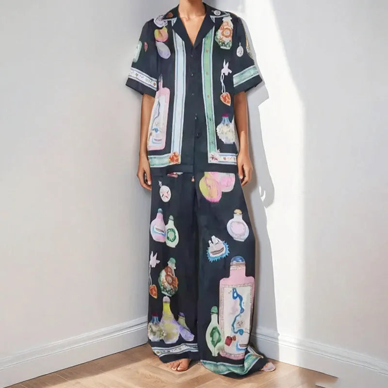 Black women's casual set with anime cartoon print, featuring a long sleeve cardigan and matching trousers.