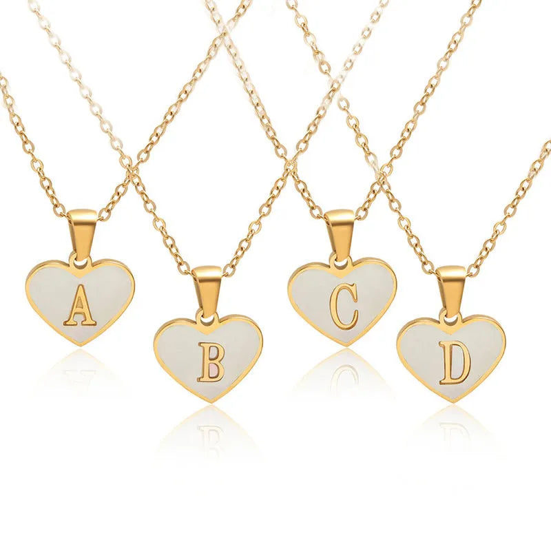 Gold plated chain necklace with a white shell heart-shaped pendant personalised with a single letter initial.
