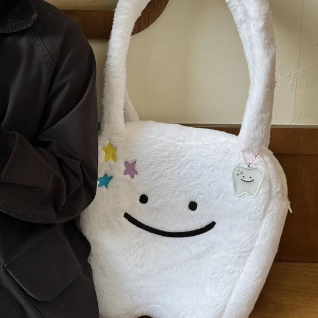 White crossbody shoulder bag with plush large tooth pattern and zipper closure