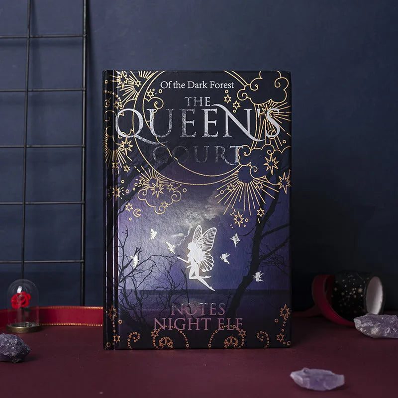 Blue luminous hardcover A5 notebook open to show full-colour illustrated pages.