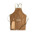 Canvas apron with cross-back straps in camel colour.