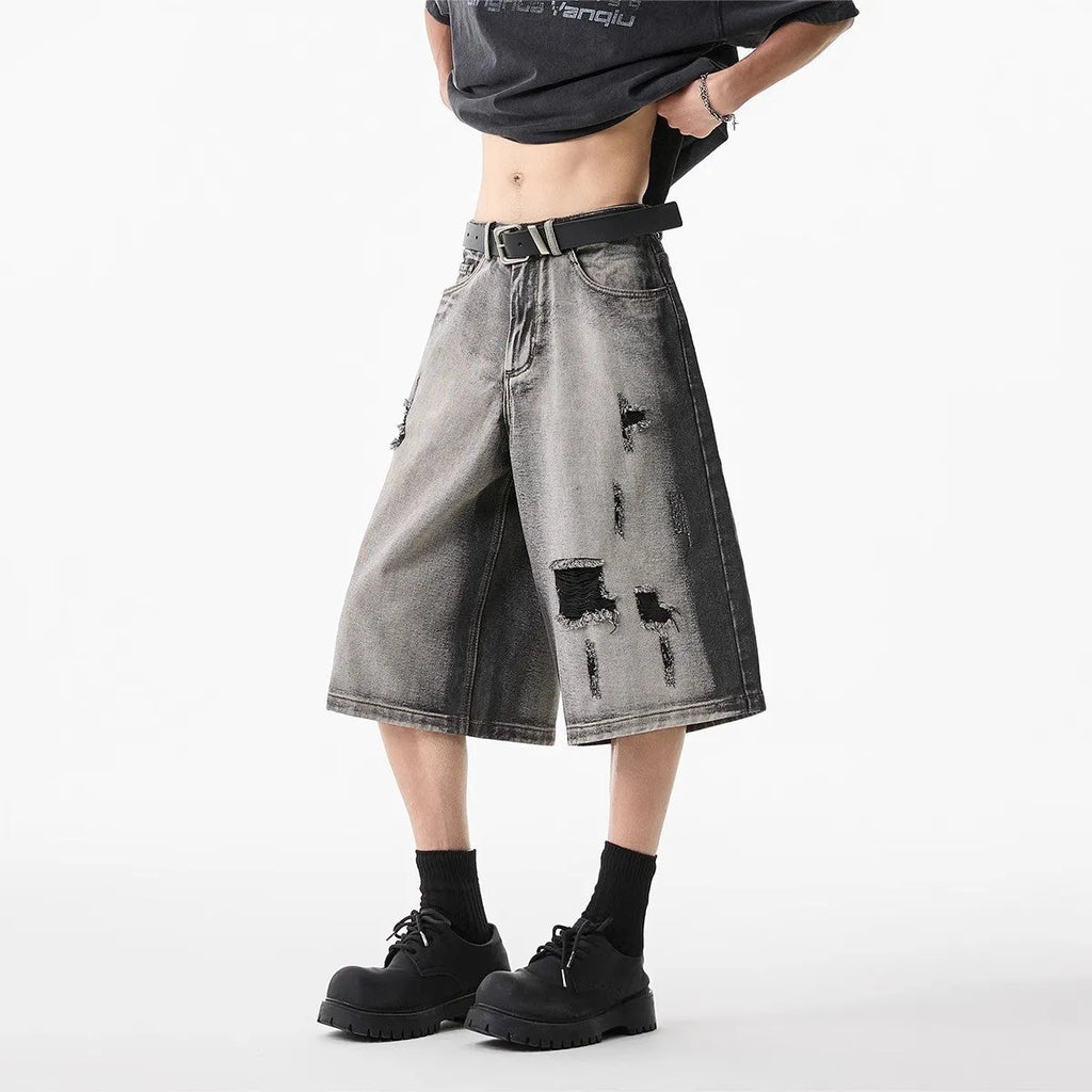 Grey distressed denim shorts with water washed finish and loose retro fit