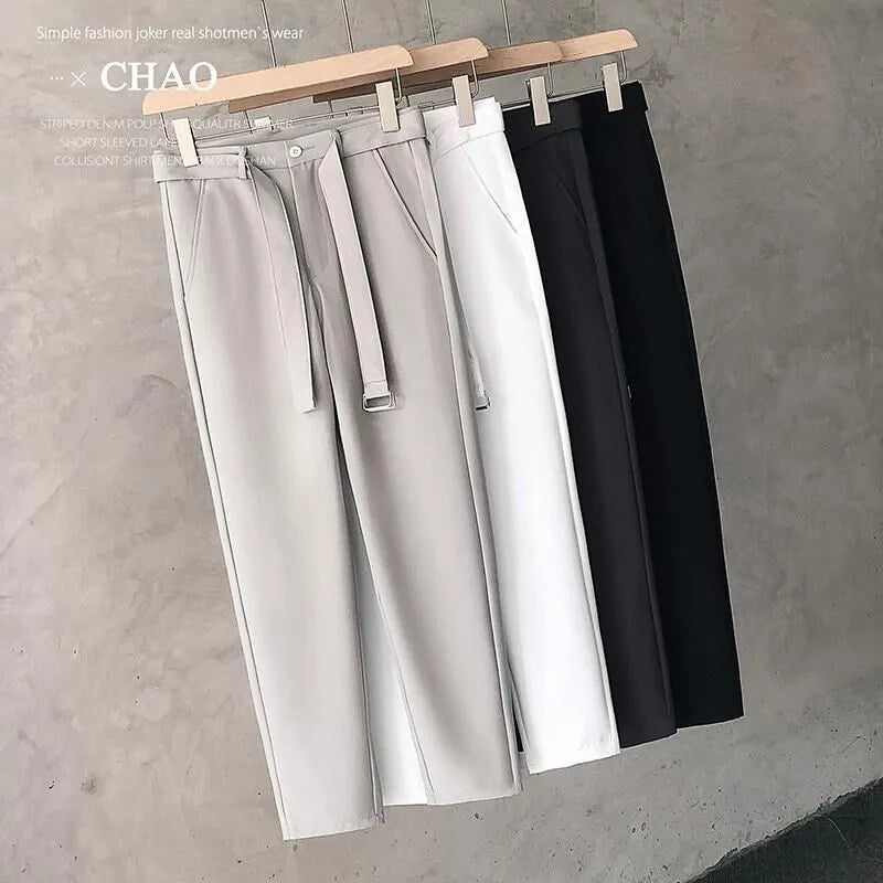 Boy wearing slim straight tapered wool trousers in grey for a business casual outfit.