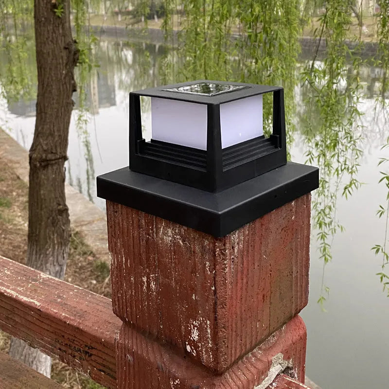 Outdoor solar pillar lamp, IP44, 160mm x 160mm x 110mm, abstract design, available in Black or White for courtyard and garden use.