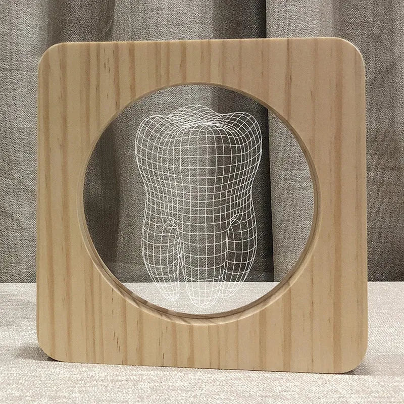 Tooth-shaped wooden-colour acrylic night lamp with USB cable on a surface.