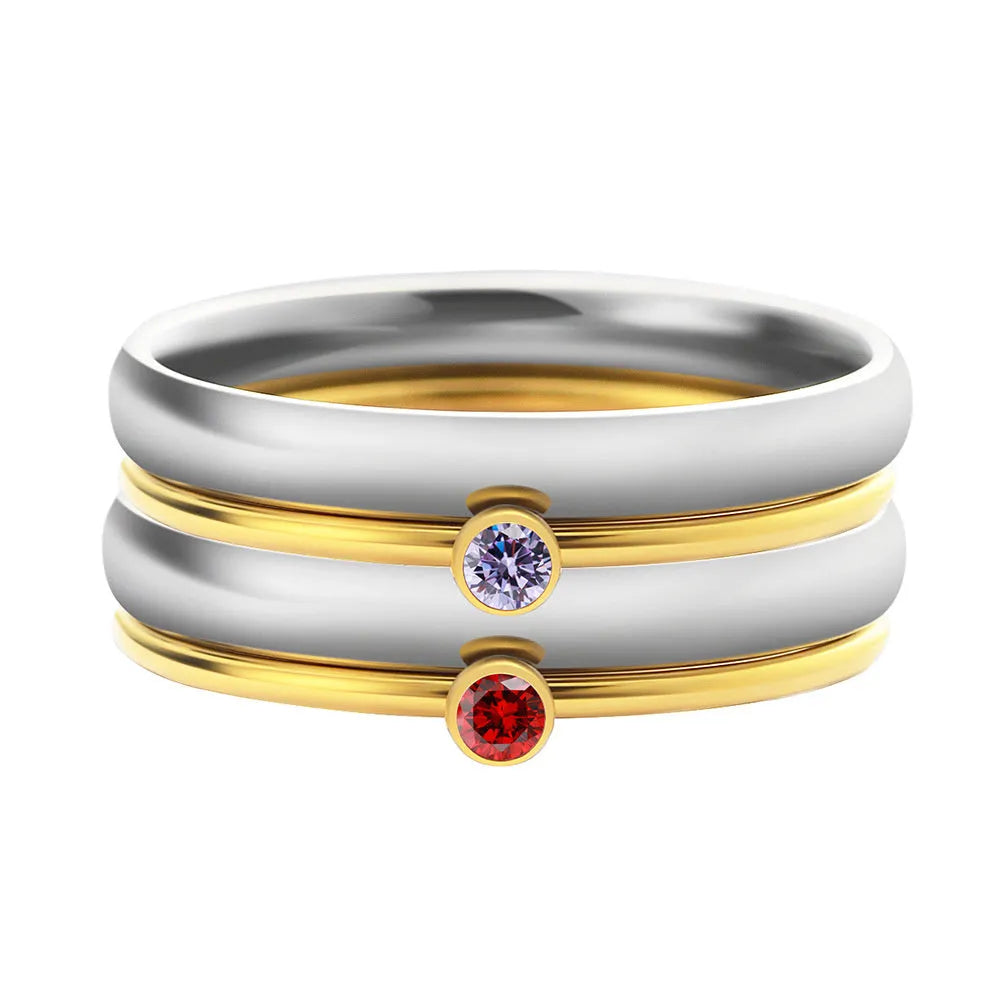 Close-up of a geometric titanium steel ring with an engraved December birthstone colour design on the band.