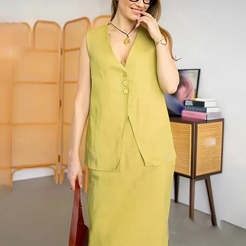 A woman wearing a blue sleeveless vest and matching long skirt from a polyester two-piece suit.