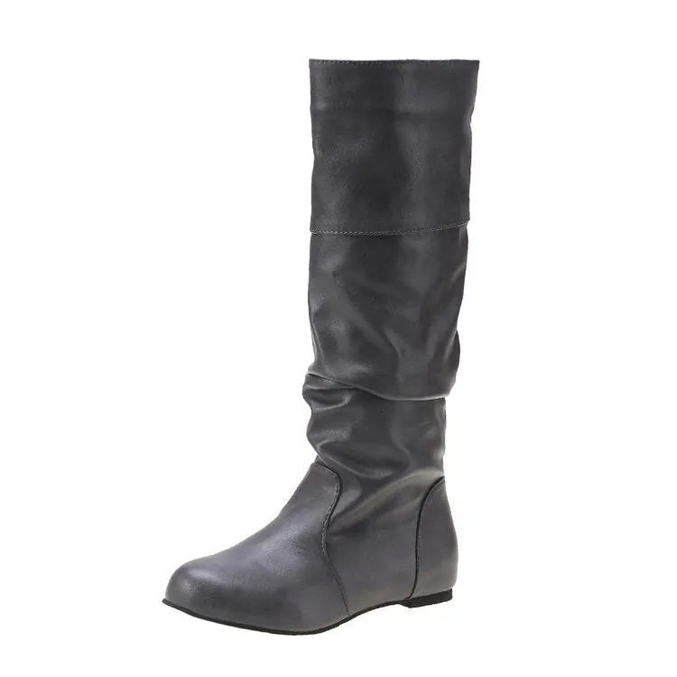 Women's flat slip-on ankle boots in black with a round toe and high-cut design on a neutral background.