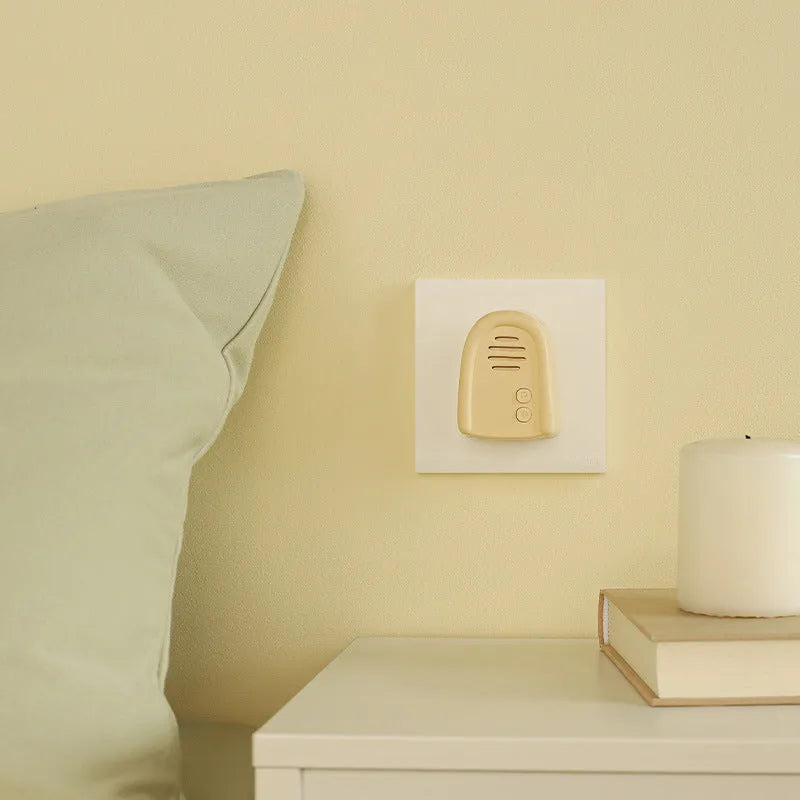 Plug-in wireless doorbell chime and self-generating battery-free button in milky yellow colour.