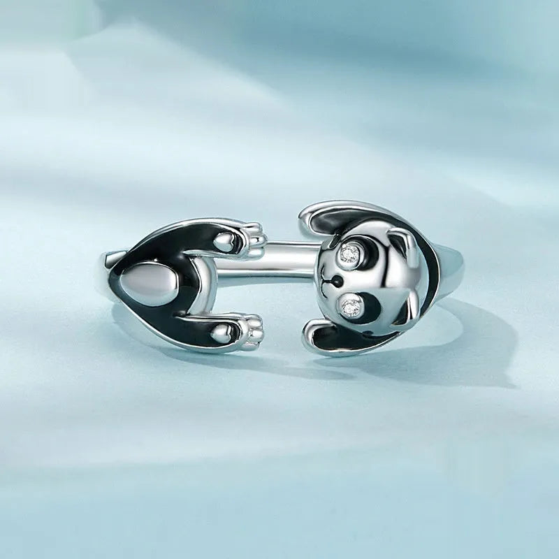 Adjustable sterling silver panda ring with white gold plating on a finger