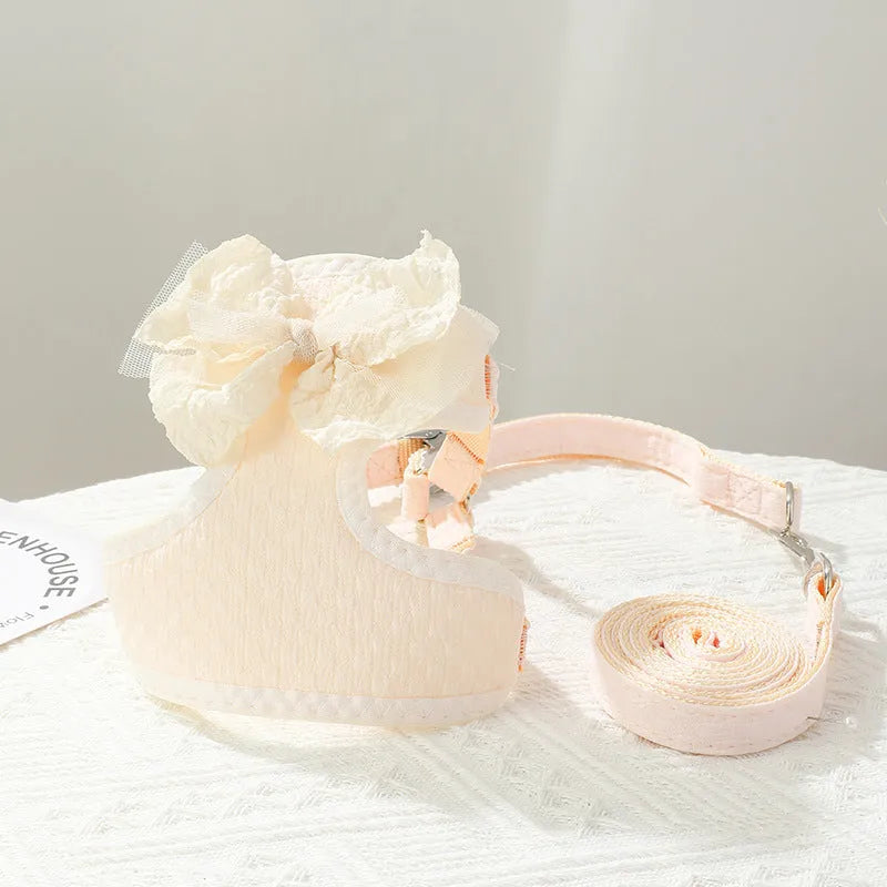 Small puppy hand-held rope chest strap in beige cloth on a wooden floor