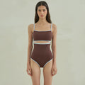 Brown women's one-piece swimsuit with triangle halter neck on a mannequin.