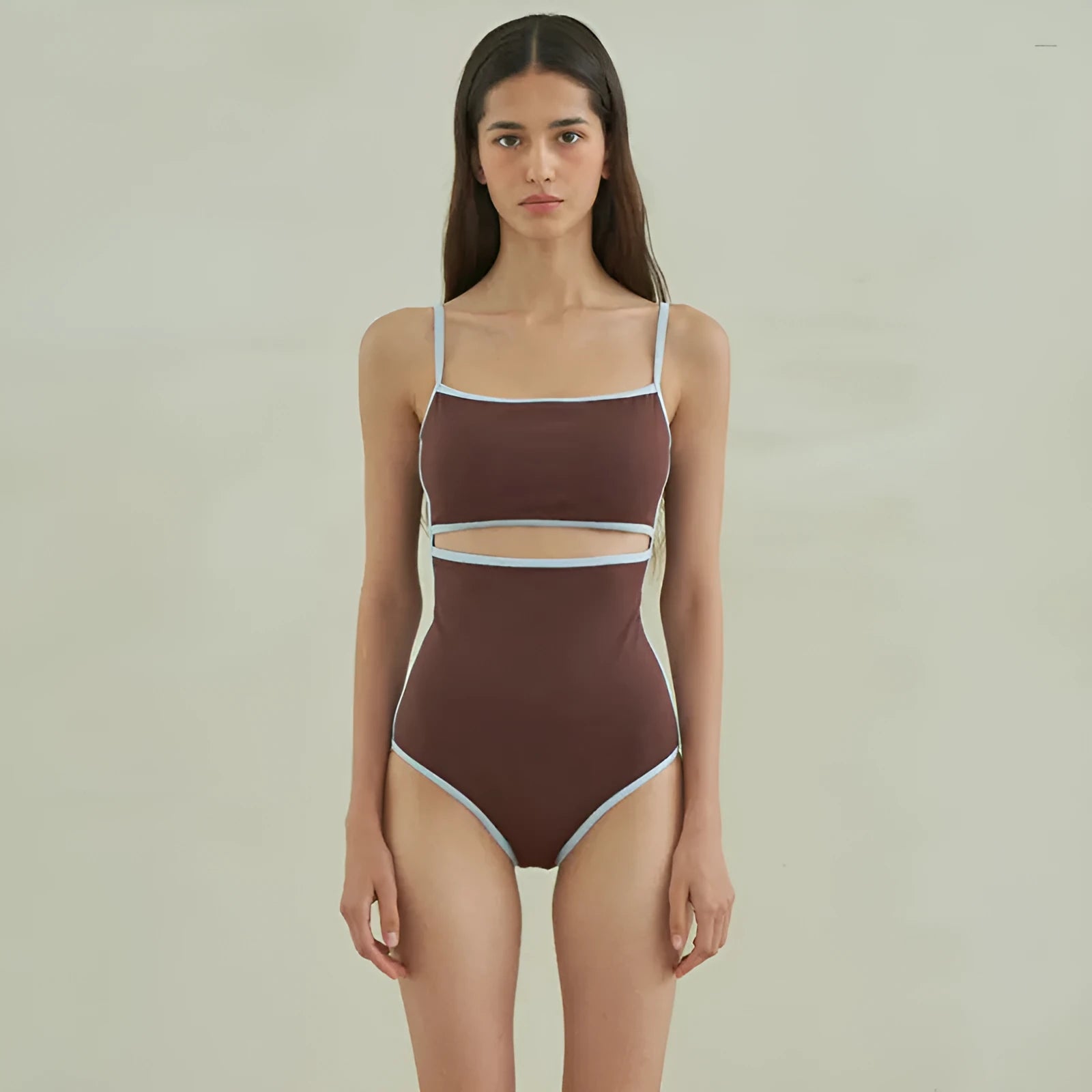 Brown women's one-piece swimsuit with triangle halter neck on a mannequin.