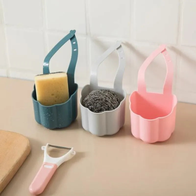 Nordic-style plastic sink drain basket in dark blue on a kitchen countertop.