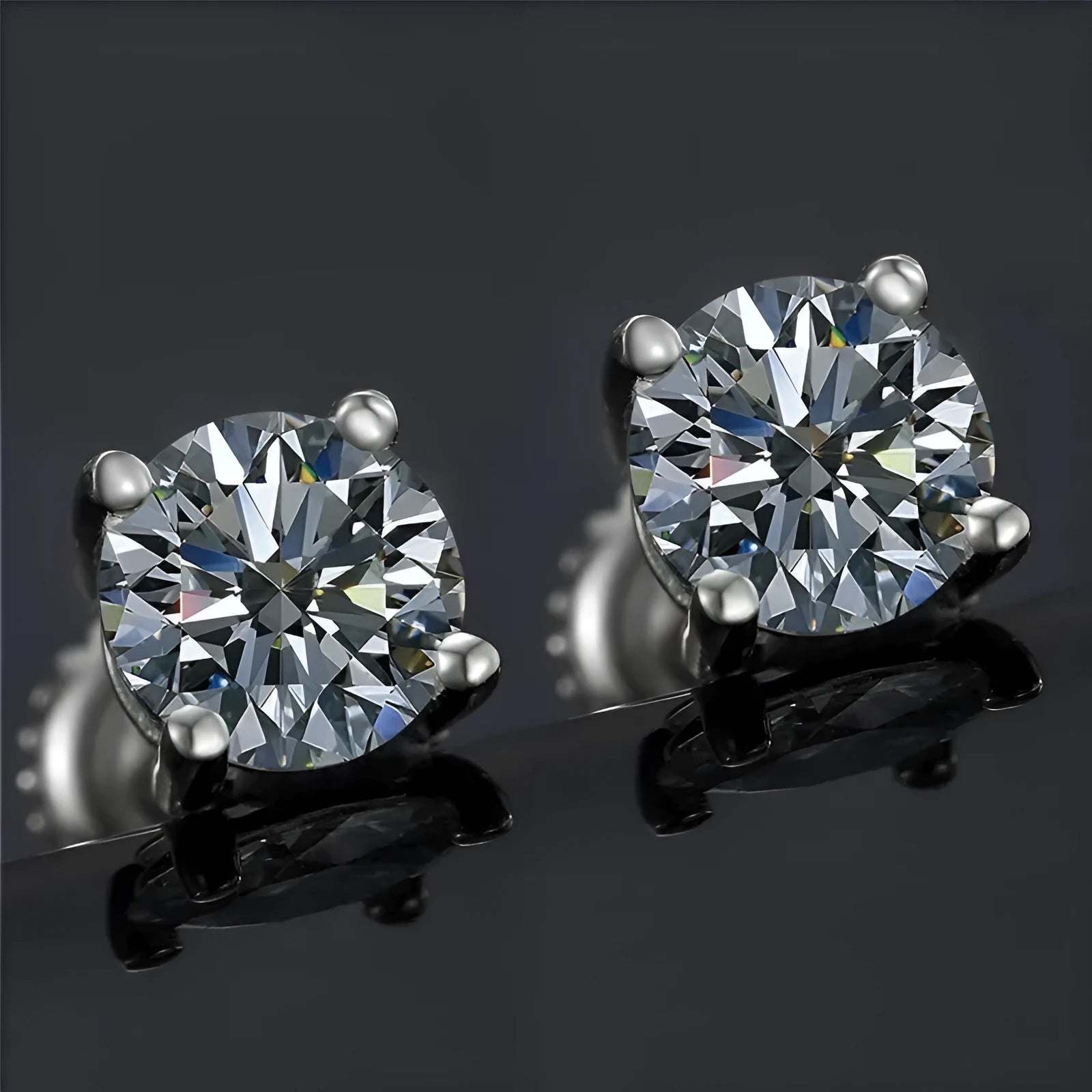 Silver geometric four claw stud earrings with moissanite stone and screw back fitting.