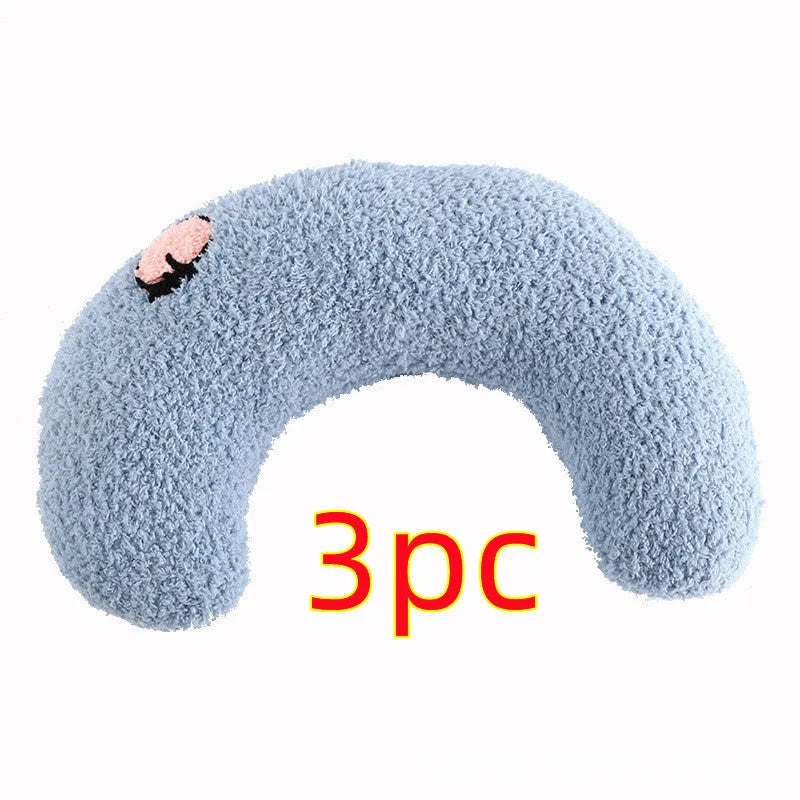 White U-shaped plush pet pillow for a cat, showing its donut shape and quilted texture.