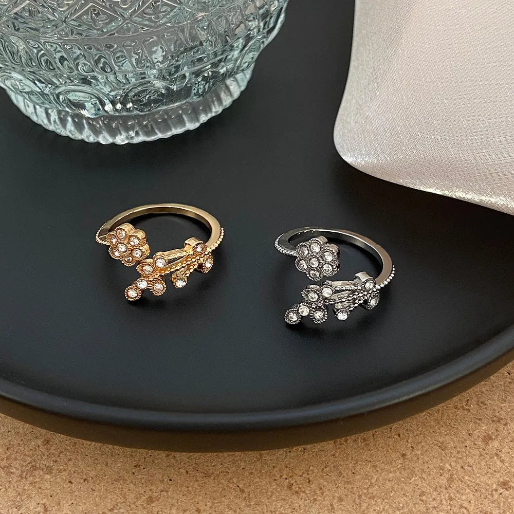 Open mouth floral ring with diamond-treated surface showing flower and leaf pattern in copper