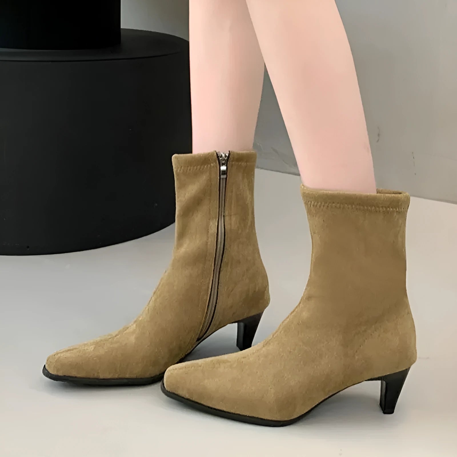 Brown women's square toe ankle boots with a side zipper and a kitten heel on a waterproof platform sole.