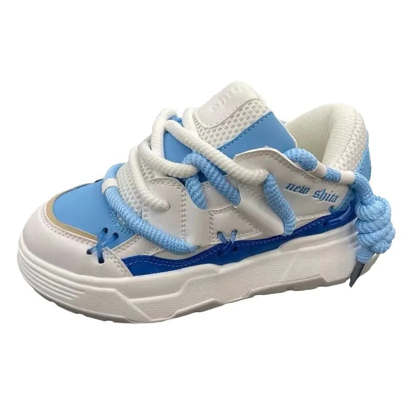 Women's black platform sneakers with thick rubber sole and lace-up front, showing round toe and chunky retro design