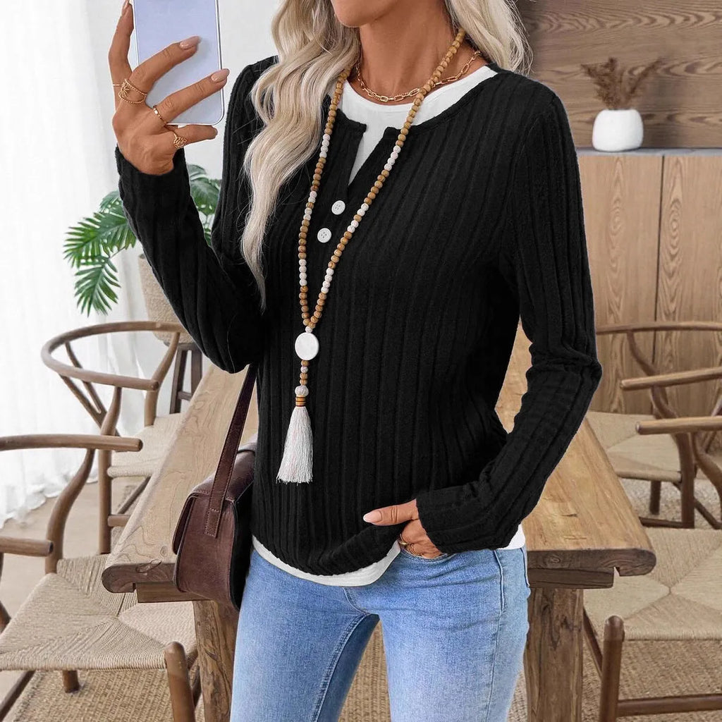 Women's black fake two-piece round neck pullover sweater with concave stripe texture and button details.