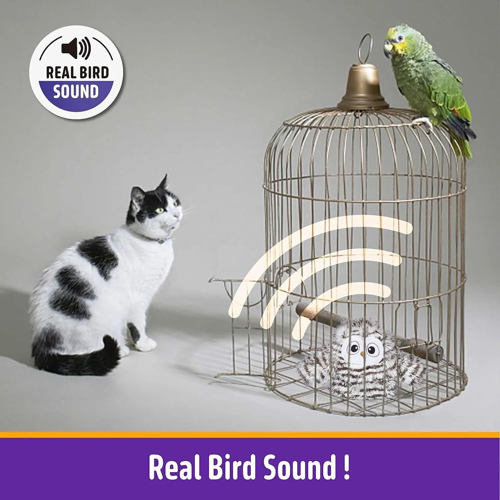 Grey automatic chirping owl cat toy with flapping wings on a floor.