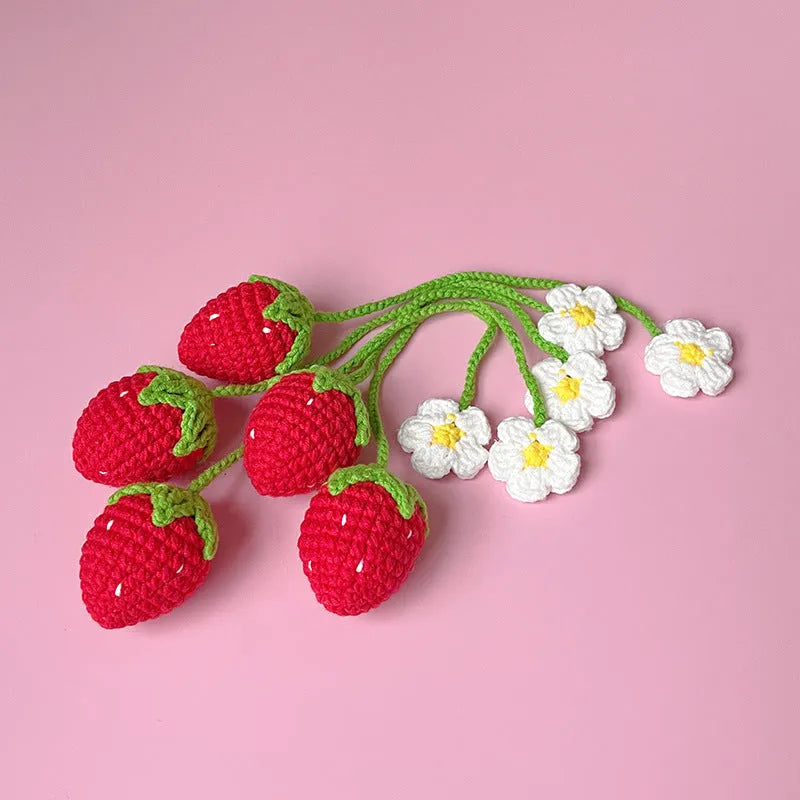 Red knitted wool strawberry pendant on 35cm cord against neutral background