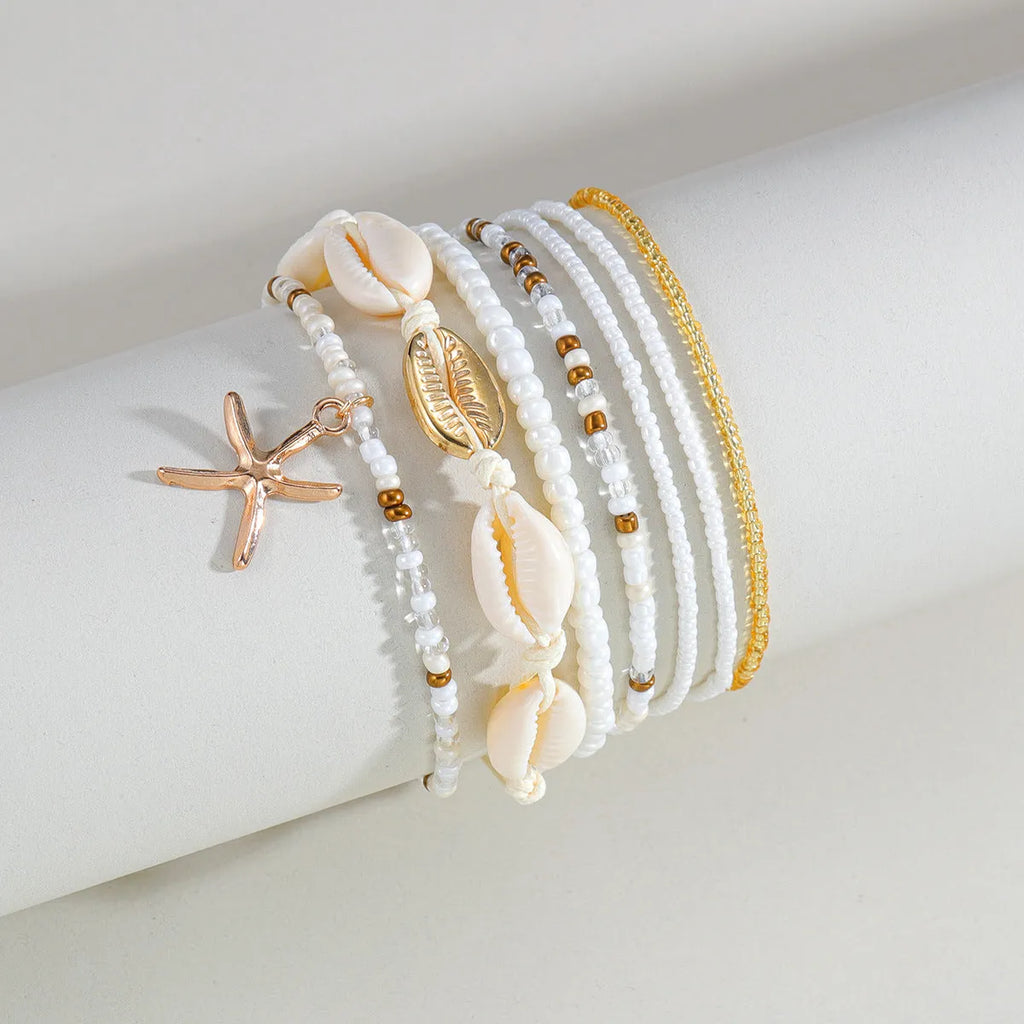 Seven-piece women's anklet set with starfish pendant, shell and rice bead details on woven wax thread, colour XY-4358