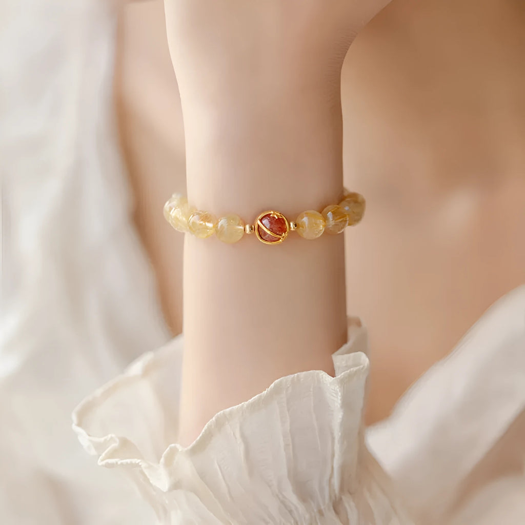 Gold rutilated quartz bracelet with diamond-cut beads in two size options