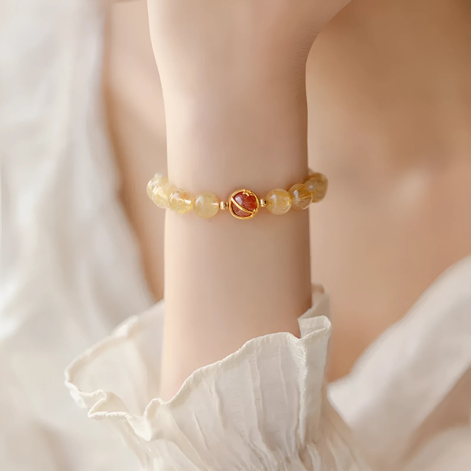 Gold rutilated quartz bracelet with diamond-cut beads in two size options