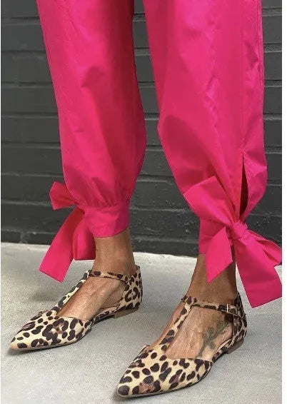 Leopard print women's pumps with pointed toe, chunky low heel, and ankle strap